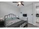 Bedroom featuring ceiling fan, grey walls, carpet and a modern, black bed frame at 32359 N 129Th Dr, Peoria, AZ 85383