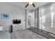 This bedroom features grey walls, carpet, ceiling fan, and a modern, black bed frame at 32359 N 129Th Dr, Peoria, AZ 85383