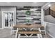 A dining table and chairs are set against a wood-paneled wall in this interior shot at 32359 N 129Th Dr, Peoria, AZ 85383