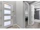 Bright entryway featuring a modern front door, wood floors, and an open view to the bedroom and bathroom at 32359 N 129Th Dr, Peoria, AZ 85383