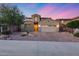 Exterior view of a two-story home featuring neutral tones, desert landscaping, brick driveway, and two car garage at 32359 N 129Th Dr, Peoria, AZ 85383