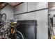 This garage offers gray cabinetry, a ladder, storage, and bicycle racks for convenience at 32359 N 129Th Dr, Peoria, AZ 85383