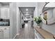 Hallway showcases tiled floors, access to the kitchen, and a decorative table at 32359 N 129Th Dr, Peoria, AZ 85383
