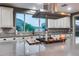Kitchen island with view of backyard, gas cooktop, and custom hood at 32359 N 129Th Dr, Peoria, AZ 85383