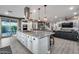 Gourmet kitchen features island with cooktop, seating, and easy access to Gathering room at 32359 N 129Th Dr, Peoria, AZ 85383