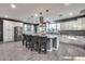 Modern kitchen boasts a large island, stainless appliances and stylish pendant lighting at 32359 N 129Th Dr, Peoria, AZ 85383