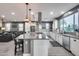 Large kitchen island with cooktop and seating overlooks living area at 32359 N 129Th Dr, Peoria, AZ 85383