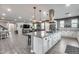 Open floor plan kitchen with island cooktop, seating, and view to Gathering room at 32359 N 129Th Dr, Peoria, AZ 85383