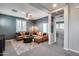 Open living room with a ceiling fan, shutters on the windows, and modern furniture at 32359 N 129Th Dr, Peoria, AZ 85383