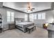 Spacious main bedroom with carpet, natural light, ceiling fan and ensuite bathroom access at 32359 N 129Th Dr, Peoria, AZ 85383