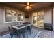 Cozy covered patio with outdoor seating, a ceiling fan, a television, and seamless transition to the indoor kitchen space at 32359 N 129Th Dr, Peoria, AZ 85383
