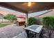Inviting covered patio with a ceiling fan, stylish furniture, and picturesque mountain views for outdoor living and relaxation at 32359 N 129Th Dr, Peoria, AZ 85383