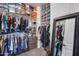 Organized walk-in closet with shelving, hanging racks, a mirror and carpet flooring at 32359 N 129Th Dr, Peoria, AZ 85383