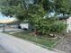 Well-maintained front yard with mature trees and xeriscaping features surrounding a charming home at 3639 W Beryl Ave, Phoenix, AZ 85051