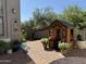Backyard featuring brick pavers, a playhouse, plants and landscaping at 3765 N Denny Way, Buckeye, AZ 85396