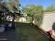 Backyard with grass, landscaping, a privacy wall, brick pavers, and a chair at 3765 N Denny Way, Buckeye, AZ 85396