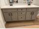 Modern bathroom with a double sink vanity, grey cabinetry and updated fixtures at 3765 N Denny Way, Buckeye, AZ 85396