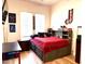 Cozy bedroom with a red comforter, a basketball theme, and natural light from the window at 3765 N Denny Way, Buckeye, AZ 85396