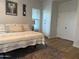 Bedroom with a neutral palette, featuring a bed, dresser, and natural light at 3765 N Denny Way, Buckeye, AZ 85396