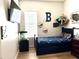 Comfortable bedroom with a mounted TV, wall decor, and playful accents for a cozy and personalized space at 3765 N Denny Way, Buckeye, AZ 85396