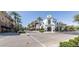 A shopping area with palm trees and an American flag at 3765 N Denny Way, Buckeye, AZ 85396