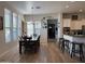 Open dining room with a large table, wine rack, and a view of the kitchen at 3765 N Denny Way, Buckeye, AZ 85396