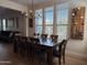 Spacious dining room with modern lighting, a wine rack, and views of the backyard at 3765 N Denny Way, Buckeye, AZ 85396