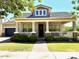 Beautiful home with a covered front porch, manicured lawn, and stone accents offers great curb appeal at 3765 N Denny Way, Buckeye, AZ 85396