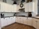 Well-lit kitchen with ample white cabinets, granite countertops, and modern backsplash at 3765 N Denny Way, Buckeye, AZ 85396