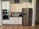 Bright kitchen featuring white cabinetry, stainless steel appliances, and modern finishes at 3765 N Denny Way, Buckeye, AZ 85396