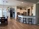 Bright, open kitchen with granite countertops, a breakfast bar, and white cabinetry at 3765 N Denny Way, Buckeye, AZ 85396