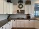 Kitchen view highlighting the white cabinets, granite countertops, and gas cooktop at 3765 N Denny Way, Buckeye, AZ 85396
