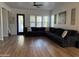 Spacious living room featuring a large sectional sofa and hardwood floors at 3765 N Denny Way, Buckeye, AZ 85396