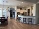 Open-concept living space with dining area, kitchen island, and modern finishes at 3765 N Denny Way, Buckeye, AZ 85396