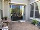 Covered patio featuring a sliding glass door, outdoor seating, textured walls and a brick paver floor at 3765 N Denny Way, Buckeye, AZ 85396