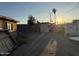 Backyard in disrepair with debris, a fence and palm trees in the distance at 3946 W Holly St, Phoenix, AZ 85009