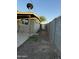 View of the backyard featuring a detached garage, a satellite dish, and a block wall at 3946 W Holly St, Phoenix, AZ 85009