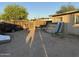 View of the backyard with a trailer, discarded materials, and a fence in the background at 3946 W Holly St, Phoenix, AZ 85009