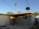 View of the backyard with a detached garage, utility lines, and a water tank at 3946 W Holly St, Phoenix, AZ 85009