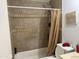 Bathroom with tiled shower and bath with shower curtain and standard white toilet at 3946 W Holly St, Phoenix, AZ 85009