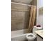 Bathroom with tiled shower and bath with shower curtain and standard white toilet at 3946 W Holly St, Phoenix, AZ 85009