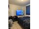 A cozy bedroom featuring a comfy bed, TV, and curtains, creating a relaxing ambiance at 3946 W Holly St, Phoenix, AZ 85009