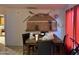 The dining room has a decorative shelf, a table, and red curtains at 3946 W Holly St, Phoenix, AZ 85009