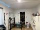 Small exercise room with free weights, bench and a storage room with shelving at 3946 W Holly St, Phoenix, AZ 85009
