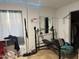 Small exercise room with free weights, bench and lit with decorative blue lights at 3946 W Holly St, Phoenix, AZ 85009