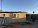 Exterior side view of home with block wall, palm trees, and debris in backyard at 3946 W Holly St, Phoenix, AZ 85009