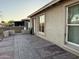 Home's outdoor area with brick-paved patio and neutral exterior siding offers a serene and low-maintenance living space at 3946 W Holly St, Phoenix, AZ 85009