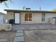 Home's exterior has desert landscaping and brick-paved patio at 3946 W Holly St, Phoenix, AZ 85009