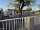 Charming home exterior featuring a cozy yard space with a shade tree, enclosed by a classic white fence at 3946 W Holly St, Phoenix, AZ 85009