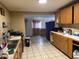 Kitchen area shows sink, cooktop, cabinets, and open access to an adjacent room at 3946 W Holly St, Phoenix, AZ 85009